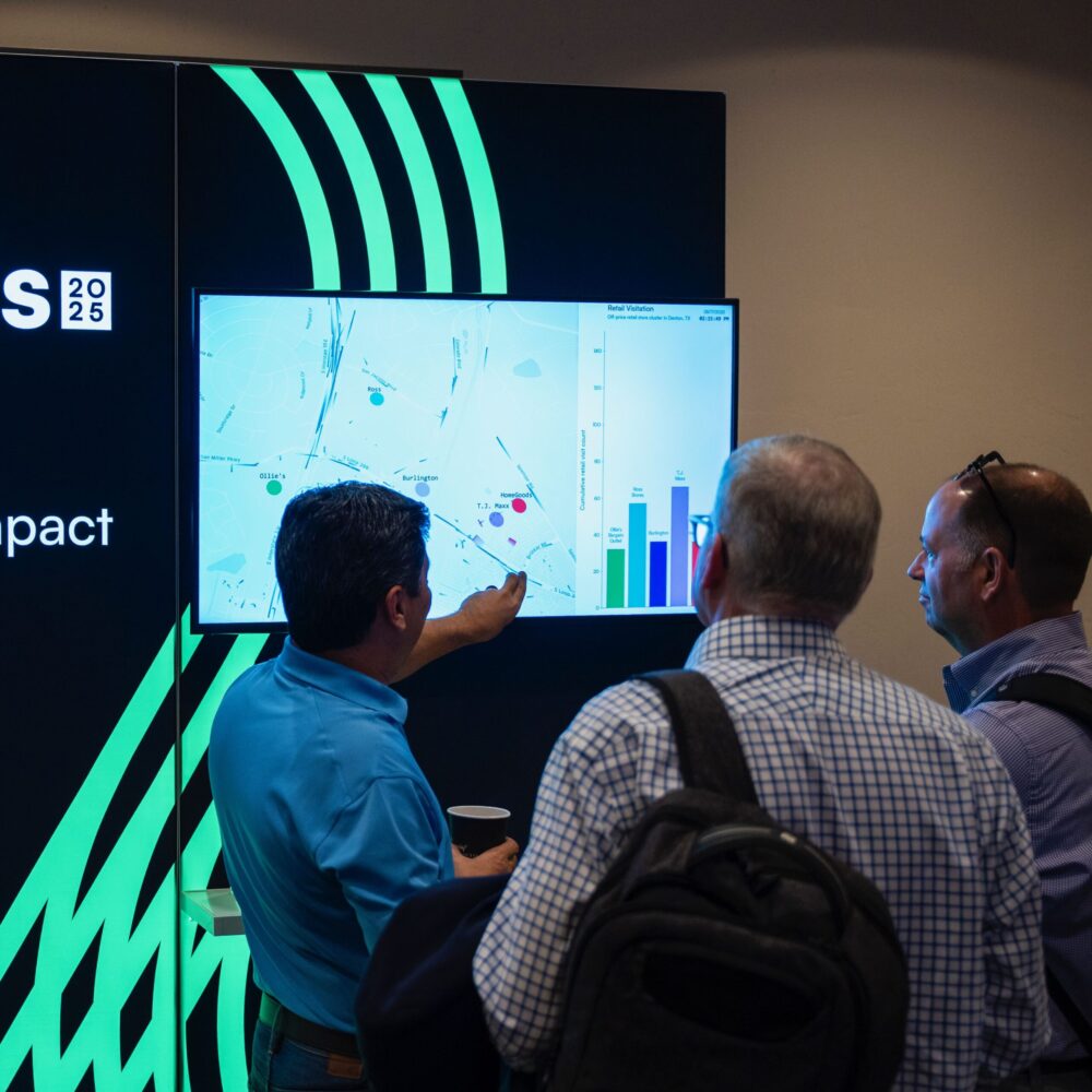 Photo of attendees looking at a data visualization