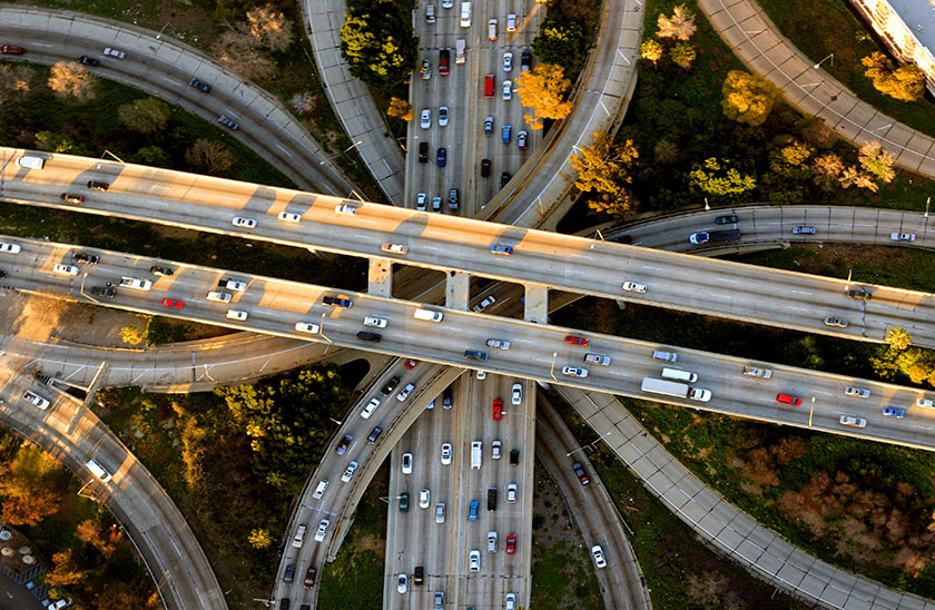 An aerial photo of multiple cars on several highways
